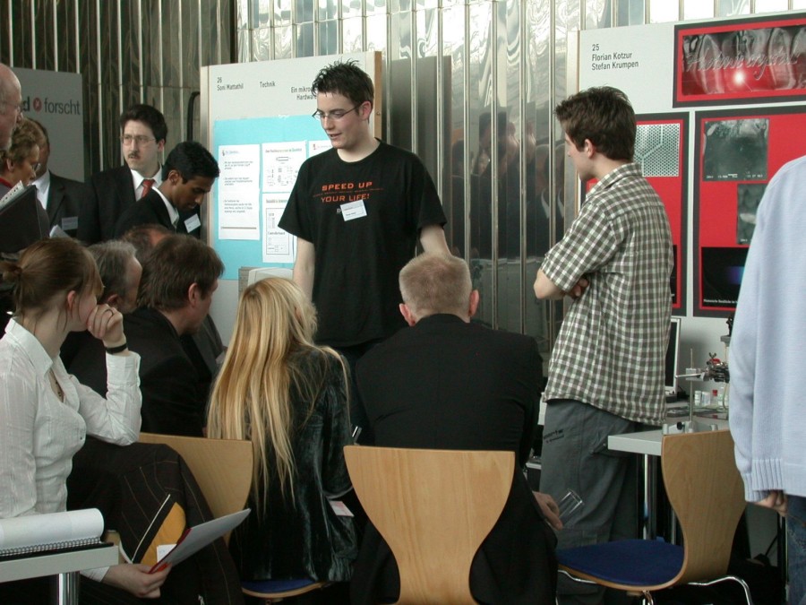 Florian and Stefan surrounded by an interested audience