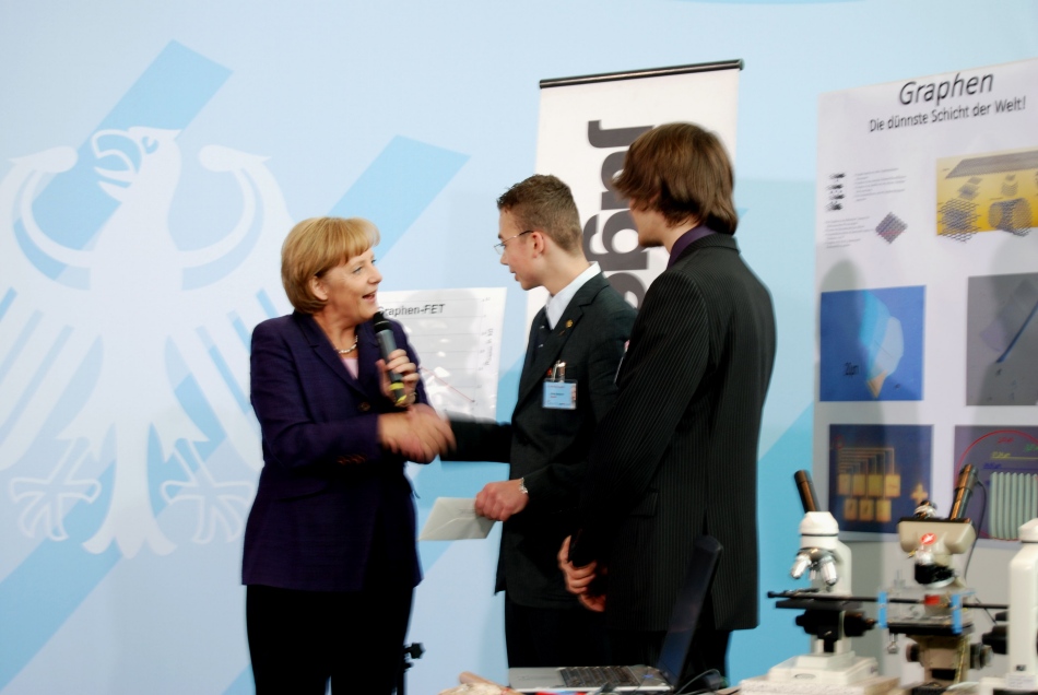 German Chancellor Dr. Anglea Merkel gives Tobias and Michael a 1700 € check