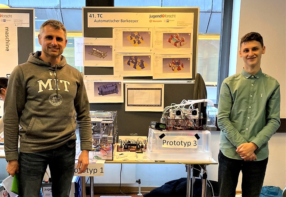Teacher Dennis Nebe and Nick Fischer with his invention at the regional competition