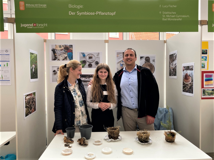 Lucy with her proud parents and her plant pots at the state competition